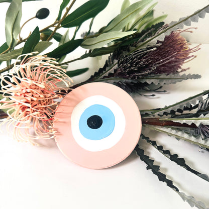 Achk Love Guardian pink evil eye wall art by Ani Ipradjian, a spiritual home decoration inspired by unconditional love and protection against jealousy.