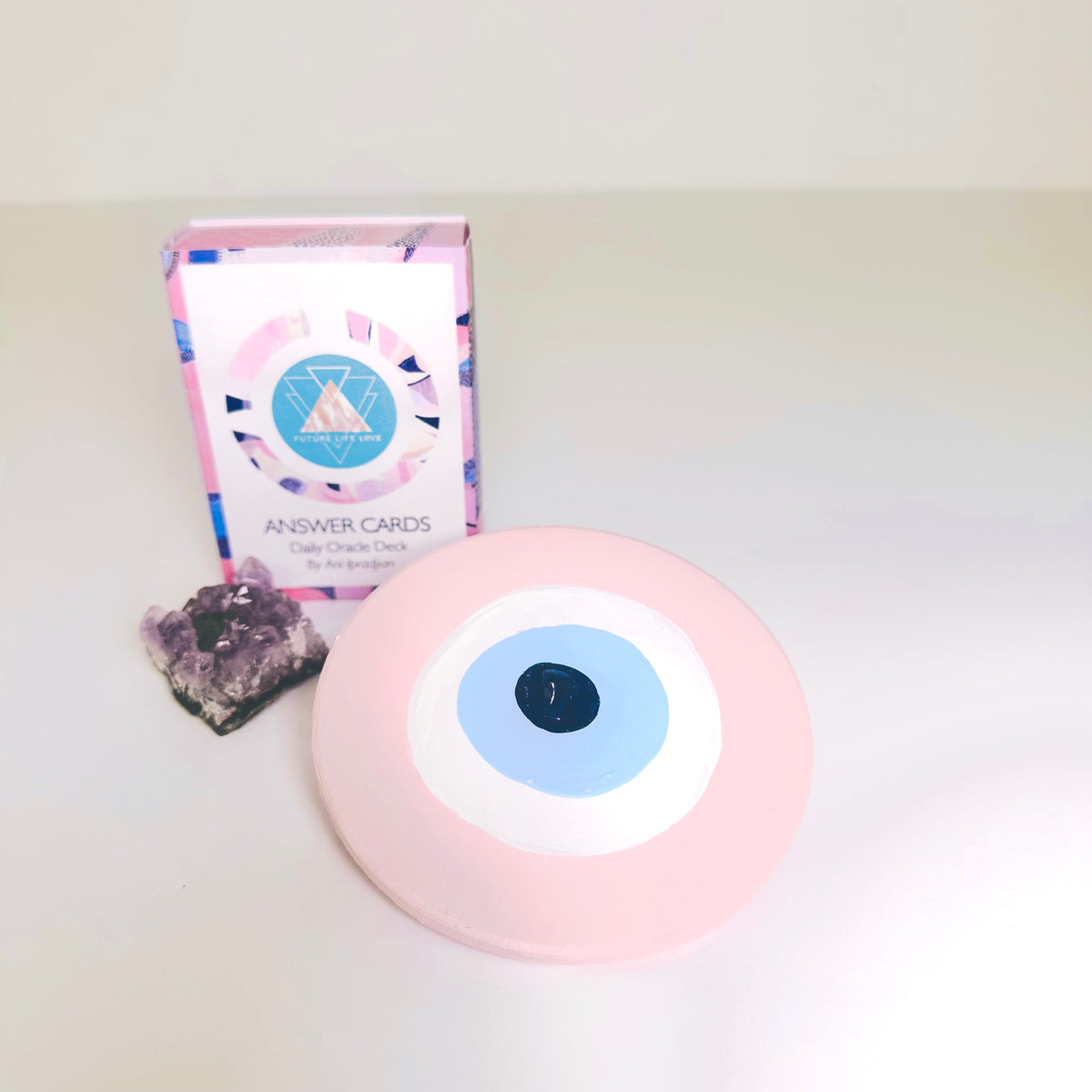Collectible pink ceramic evil eye amulet by Ani Ipradjian, an Achk spiritual protection wall hanging symbolising compassion, love and emotional wellbeing.