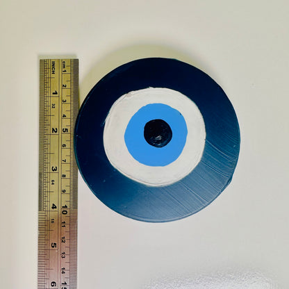 Dark blue evil eye ceramic amulet by Australian artist Ani Ipradjian, Achk Divine Guardian Number Two wall hanging symbolising strength and spiritual grounding.