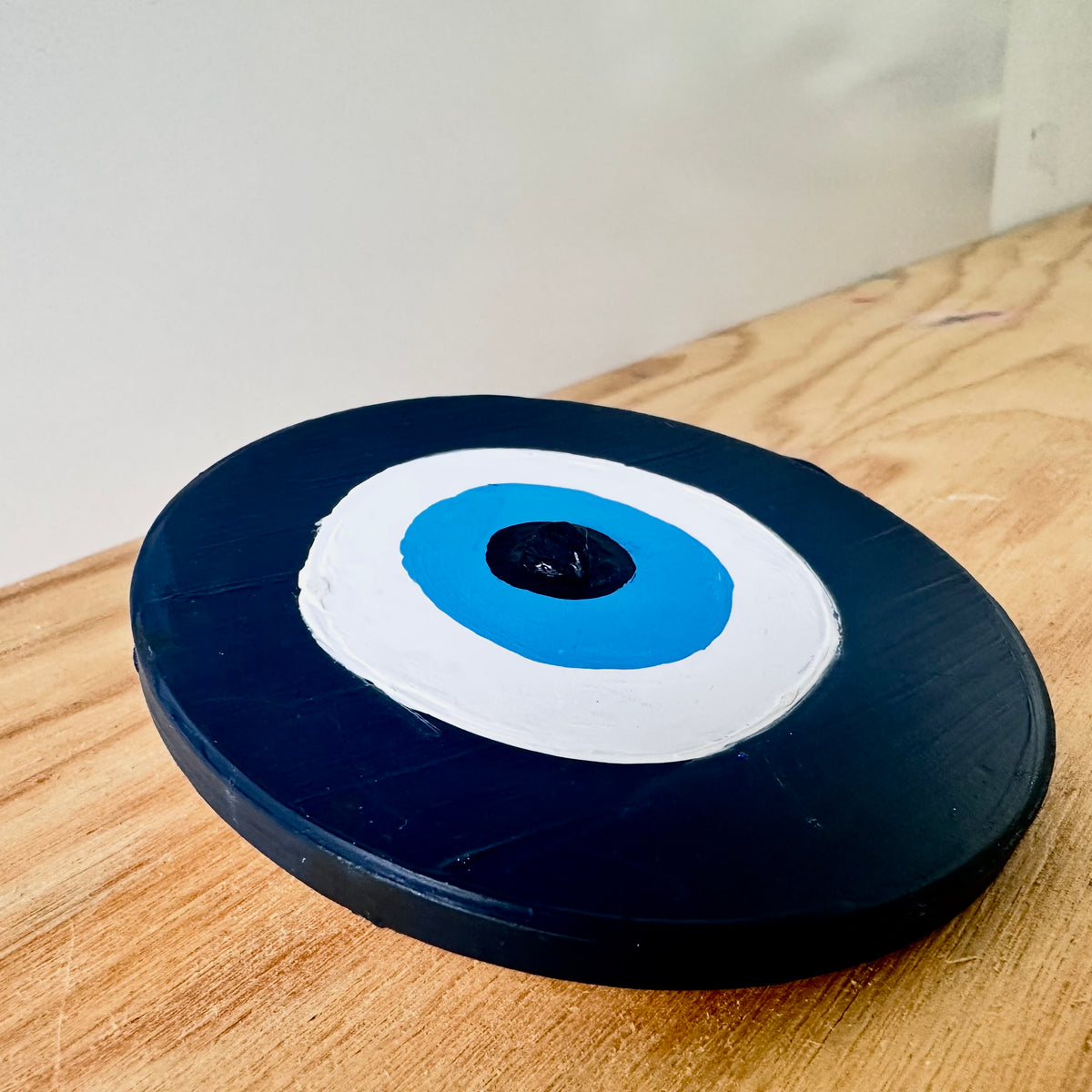 Divine Guardian Number Two dark blue evil eye amulet by Ani Ipradjian, an Achk ceramic wall hanging symbolising wisdom, spiritual armour and protection from envy.