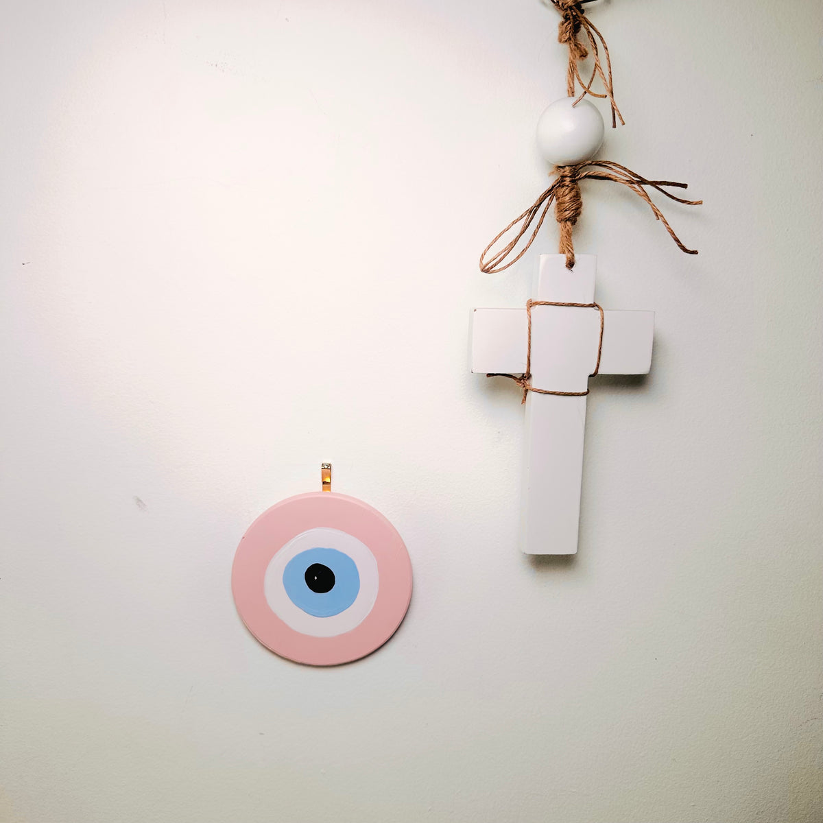 Hand-painted Achk pink evil eye amulet by artist Ani Ipradjian, a ceramic evil eye wall hanging symbolising love, harmony and positive relationships.