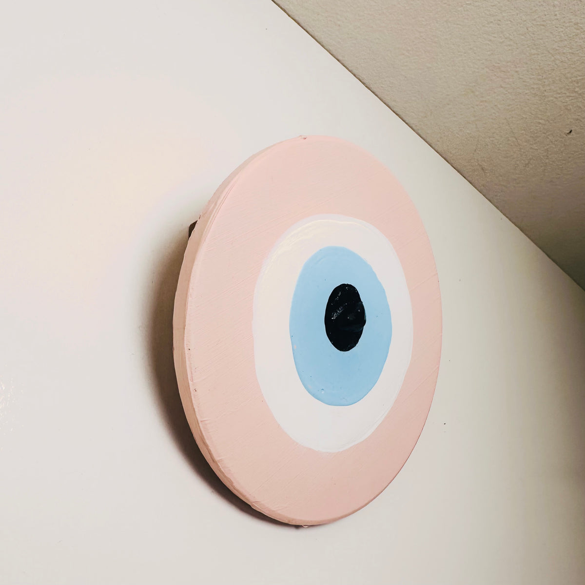 Love Guardian Achk pink evil eye wall hanging by Ani Ipradjian, handcrafted ceramic art representing healing after heartbreak and welcoming new love.