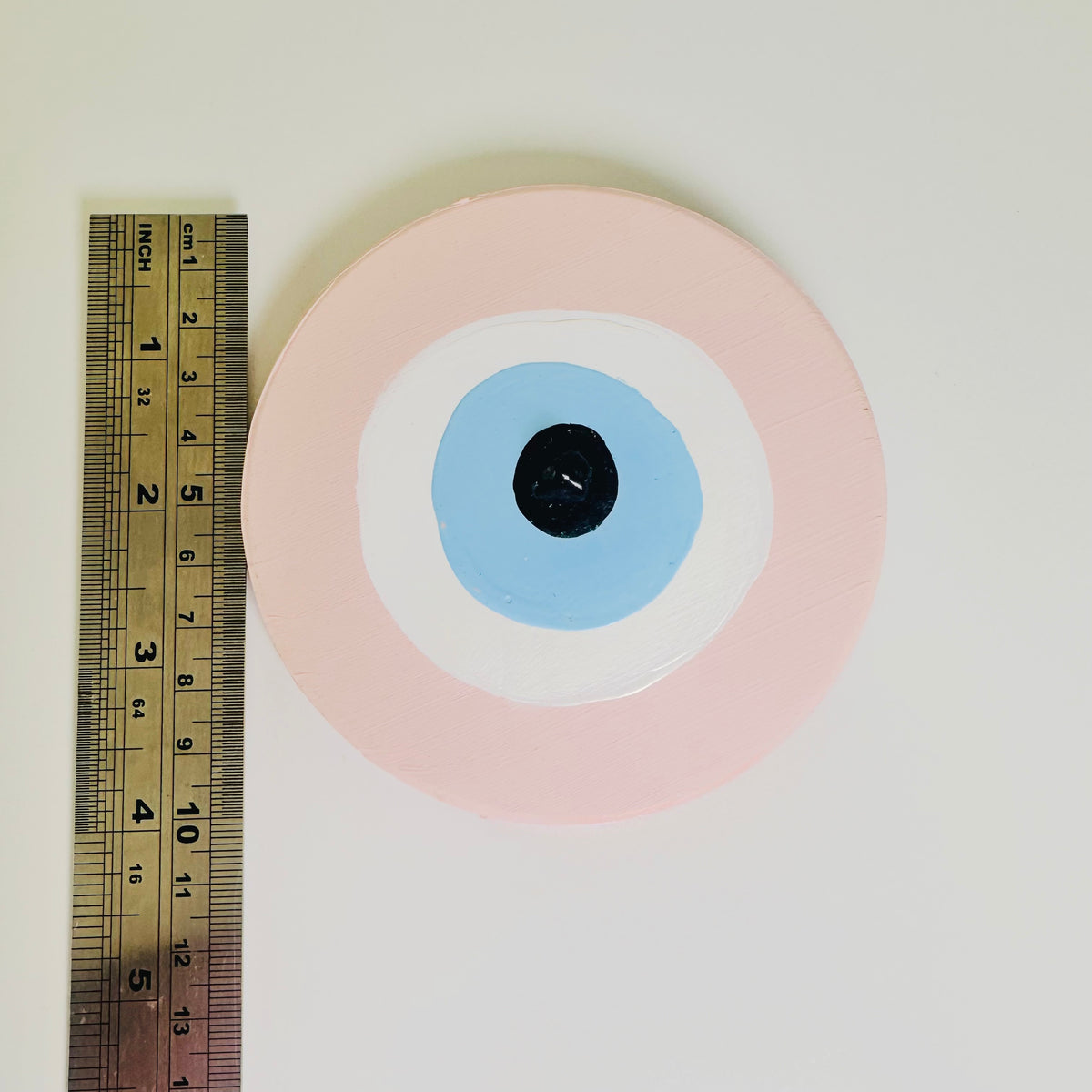 Love Guardian handmade pink evil eye ceramic amulet by Australian artist Ani Ipradjian, an Achk artwork symbolising self-love, emotional strength and renewal.