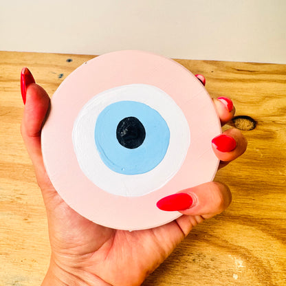 Love Guardian pink ceramic evil eye by Ani Ipradjian, an Achk spiritual wall hanging representing true love, self-worth and protection against jealousy.
