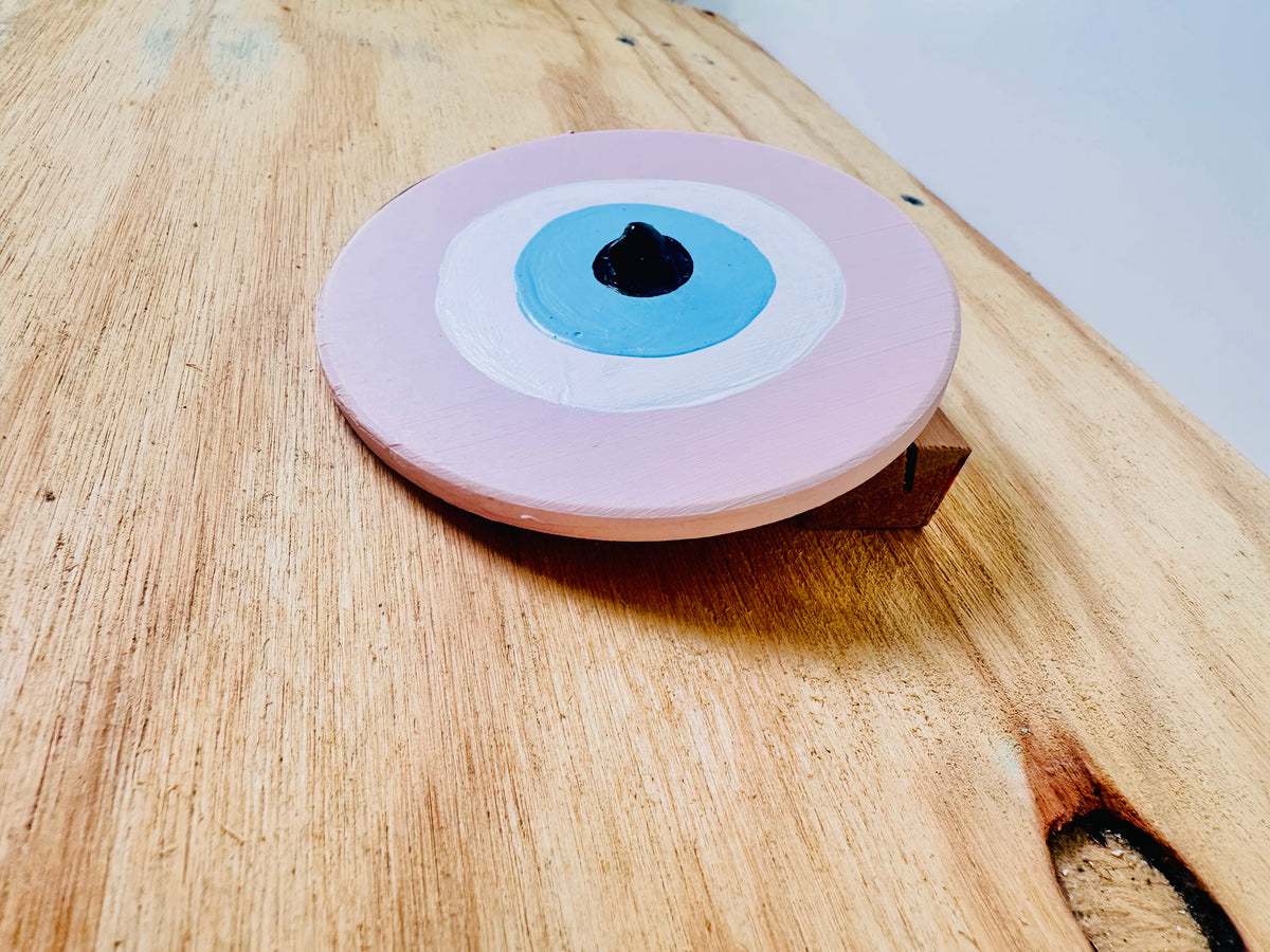 Pink ceramic evil eye wall hanging from Achk by artist Ani Ipradjian, a meaningful love and protection gift for weddings, anniversaries and housewarmings.